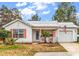 Charming single story home featuring tidy landscaping, an American flag, and a metal roof at 9514 Leeds Circle, Myrtle Beach, SC 29588