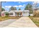 The exterior of a single story home featuring tidy landscaping, an American flag, and a metal roof at 9514 Leeds Circle, Myrtle Beach, SC 29588