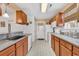 Well-lit kitchen with wood cabinets, neutral countertops, and modern appliances for a timeless design at 9514 Leeds Circle, Myrtle Beach, SC 29588