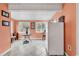 Bright eat-in kitchen features tile floors, white refrigerator, and natural light from the double windows with views at 9514 Leeds Circle, Myrtle Beach, SC 29588
