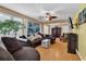 Living room featuring hardwood floors, a ceiling fan and a cozy fireplace for ambiance at 9514 Leeds Circle, Myrtle Beach, SC 29588