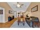 A spacious living room offering a ceiling fan, and open view to the kitchen, and hardwood flooring at 9514 Leeds Circle, Myrtle Beach, SC 29588