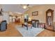 A living room featuring hardwood floors, a ceiling fan, an open view to the kitchen and neutral colors at 9514 Leeds Circle, Myrtle Beach, SC 29588