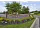 Brick community sign for Brighton Woods featuring colorful landscaping at 9514 Leeds Circle, Myrtle Beach, SC 29588