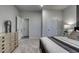 Neutral bedroom with soft carpet, dresser, and door to the en-suite bathroom at 971 Laconic Dr., Myrtle Beach, SC 29588