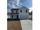 Charming two-story home features a covered porch, attached garage, and well-manicured lawn at 971 Laconic Dr., Myrtle Beach, SC 29588