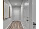Inviting hallway with wood floors and modern artwork features multiple doors leading to other rooms at 971 Laconic Dr., Myrtle Beach, SC 29588