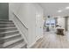 Open-concept living area with wood floors, staircase, and bright windows overlooking the outdoors at 971 Laconic Dr., Myrtle Beach, SC 29588