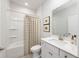 Clean bathroom with a shower-tub combo, single sink vanity, framed mirror, and tiled flooring at 981 Laconic Dr., Myrtle Beach, SC 29588