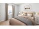 Comfortable bedroom showcasing a tufted headboard, neutral color palette, and natural light from a window at 981 Laconic Dr., Myrtle Beach, SC 29588