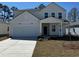 Charming two-story home featuring a two-car garage, covered entry, and landscaped front yard at 985 Laconic Dr., Myrtle Beach, SC 29588