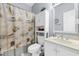 Cozy bathroom with seashell shower curtain, white vanity, and tile flooring at 1058 Sea Mountain Hwy. # 14-302, North Myrtle Beach, SC 29582