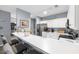 Bright kitchen with a spacious counter bar, stainless steel refrigerator, and white cabinets at 1058 Sea Mountain Hwy. # 14-302, North Myrtle Beach, SC 29582