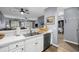 Clean kitchen with white cabinets, stainless steel dishwasher, and view to the living room at 1058 Sea Mountain Hwy. # 14-302, North Myrtle Beach, SC 29582
