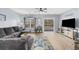 Bright living room featuring a comfortable sofa, modern decor, and access to a balcony at 1058 Sea Mountain Hwy. # 14-302, North Myrtle Beach, SC 29582