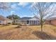 Back of house with a screened in porch, deck and a well maintained lawn at 1107 Swan Lake Dr., North Myrtle Beach, SC 29582