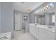 Well-lit primary bathroom with double sinks, a large mirror, and blue wallpaper at 1107 Swan Lake Dr., North Myrtle Beach, SC 29582