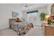 Cozy bedroom with neutral walls and carpet, ceiling fan, and large window offering natural light at 1107 Swan Lake Dr., North Myrtle Beach, SC 29582