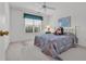 Bright bedroom features a ceiling fan, neutral walls and carpet, plus a window providing ample natural light at 1107 Swan Lake Dr., North Myrtle Beach, SC 29582