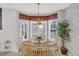 Cozy breakfast nook featuring a bay window, round table, and floral wallpaper at 1107 Swan Lake Dr., North Myrtle Beach, SC 29582