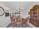 Open dining area flowing from the living area, featuring a wooden table and china cabinet at 1107 Swan Lake Dr., North Myrtle Beach, SC 29582