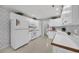 Functional kitchen with white appliances, ample counter space, and classic floral wallpaper at 1107 Swan Lake Dr., North Myrtle Beach, SC 29582