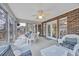 Relaxing sunroom with abundant natural light, white wicker furniture and views of the outdoor greenery at 1107 Swan Lake Dr., North Myrtle Beach, SC 29582