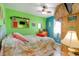 Cozy bedroom with a ceiling fan, tropical decor and a bright accent wall at 123 Dogwood Dr. N # 205-A, Murrells Inlet, SC 29576