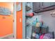 Linen closet with wire shelves and orange wall in hallway at 123 Dogwood Dr. N # 205-A, Murrells Inlet, SC 29576