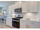 Well-equipped kitchen with stainless steel appliances, white countertops, and ample cabinet space at 1275 Winding Creek Way, Myrtle Beach, SC 29588