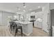 Modern, open kitchen with a large island, stainless steel appliances, and bright white cabinetry at 1275 Winding Creek Way, Myrtle Beach, SC 29588