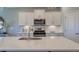 Modern kitchen featuring island with sink, white cabinets and countertops, and stainless steel appliances at 1275 Winding Creek Way, Myrtle Beach, SC 29588