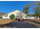 The exterior of this charming single-Gathering home features a spacious backyard with a white picket fence at 152 Rose Water Loop, Myrtle Beach, SC 29588