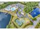 Aerial view of a community with multiple pools, tennis court, and a lake at 1547 Harlow Ct., Myrtle Beach, SC 29579