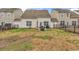 View of the backyard with partial grass cover, surrounded by a black metal fence at 1547 Harlow Ct., Myrtle Beach, SC 29579