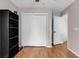 Bedroom with wood floors, closet with white doors, and a black bookshelf at 1547 Harlow Ct., Myrtle Beach, SC 29579