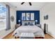Primary bedroom featuring a ceiling fan, large window, and a blue accent wall at 1547 Harlow Ct., Myrtle Beach, SC 29579