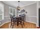 Cozy dining room featuring hardwood floors, a modern light fixture, and a large window at 1547 Harlow Ct., Myrtle Beach, SC 29579
