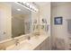 Clean bathroom with double sinks, a large mirror, and a glass-enclosed shower for a modern feel at 1581 South Waccamaw Dr. # 304, Garden City Beach, SC 29576