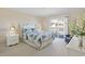 Bright bedroom featuring a balcony, comfortable bed, and a view of the building's exterior at 1581 South Waccamaw Dr. # 304, Garden City Beach, SC 29576