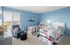 Nautical themed bedroom offers twin beds, chair, and bright natural light at 1581 South Waccamaw Dr. # 304, Garden City Beach, SC 29576