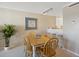 Dining area featuring a wooden table with seating, adjacent to a bar counter and open kitchen at 1581 South Waccamaw Dr. # 304, Garden City Beach, SC 29576
