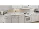 Well-maintained kitchen features white cabinetry, modern appliances, and ample countertop space at 1581 South Waccamaw Dr. # 304, Garden City Beach, SC 29576