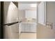 Well-lit kitchen with stainless steel refrigerator and white cabinets offering ample storage space at 1581 South Waccamaw Dr. # 304, Garden City Beach, SC 29576