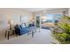 Cozy living room showcases balcony access with a view of the beach at 1581 South Waccamaw Dr. # 304, Garden City Beach, SC 29576