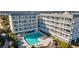 Aerial view of resort-style pool surrounded by condos, lush landscaping, and comfortable lounge seating at 1581 South Waccamaw Dr. # 304, Garden City Beach, SC 29576