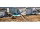 Inviting swimming pool is nestled between condos with chairs for relaxation and community fun at 1581 South Waccamaw Dr. # 304, Garden City Beach, SC 29576