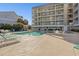 Inviting community pool with clear water and ample seating for relaxation and socializing at 1581 South Waccamaw Dr. # 304, Garden City Beach, SC 29576