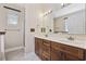 Bathroom featuring double vanity with wood cabinets and a large mirror at 197 Black Bear Rd., Myrtle Beach, SC 29588