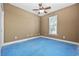 Bare bedroom with a ceiling fan, window, and blue flooring ready for renovation at 197 Black Bear Rd., Myrtle Beach, SC 29588